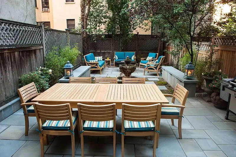 Bluestone patio with teak furniture built behind a Bergen County home